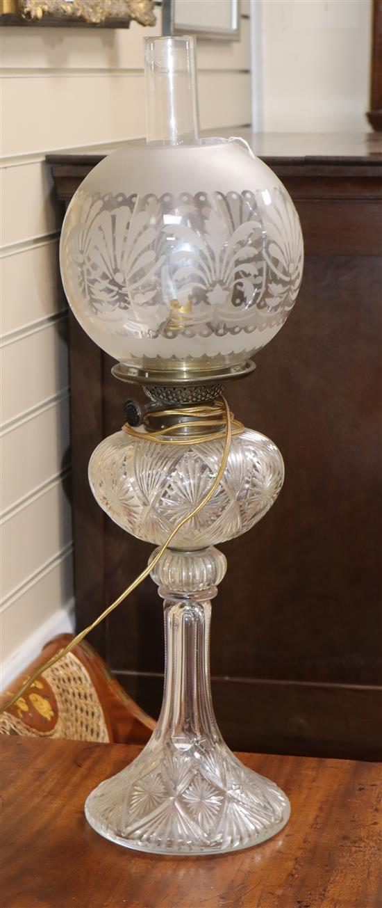 A cut glass oil lamp with shades overall height 65cm